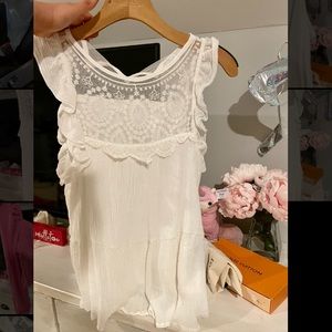 white ruffled sleeveless shirt